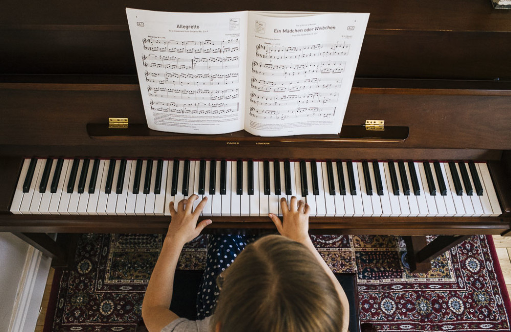 Above view of a child playing piano