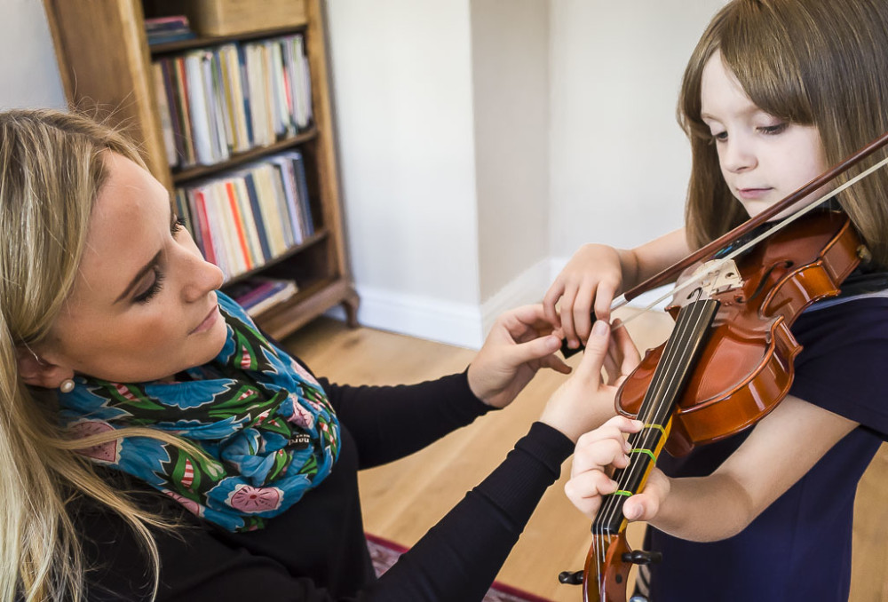 Clare teaching violin